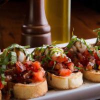 Brushetta · Slices of Italian bread, topped with chopped tomatoes, garlic, basil, olive oil a pinch of s...