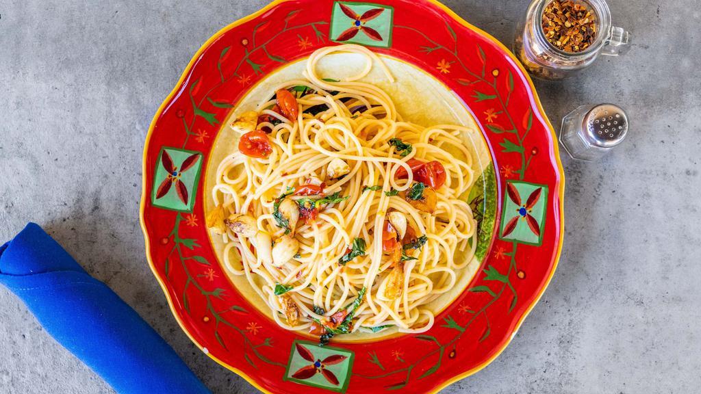 Spaghetti Aglio E Olio · Traditional Italian pasta dish from Naples, sauteed garlic in olive oil, red chili flakes, anchovies and basil.