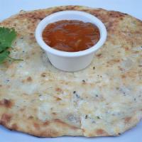 Chicken Naan · Naan stuffed with tandoor-cooked marinated chicken served with sweet tomato chutney.
