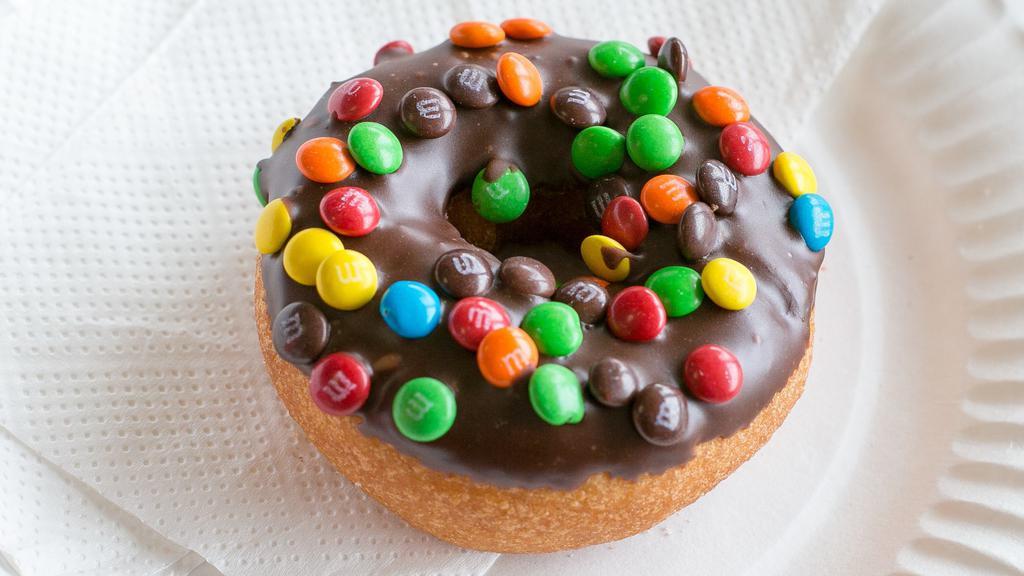 M & M'S · Vanilla cake donut with chocolate icing, topped with M & M’s