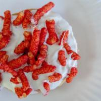 Flamin Cheeto · Raised yeast donut with white chocolate vanilla icing, topped with Flamin' Hot Cheetos.