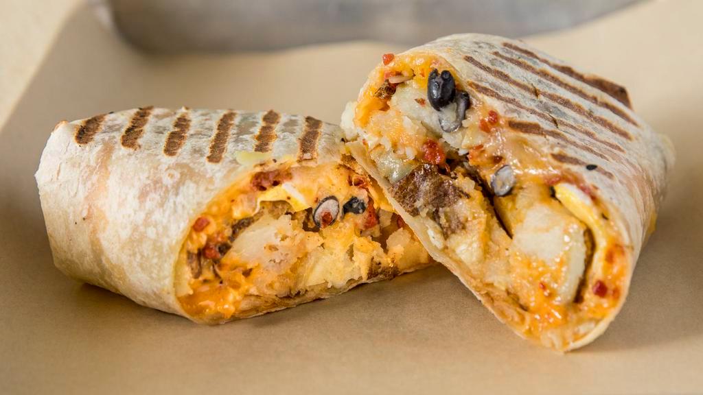 Breakfast Burrito · Seasoned golden potato wedges, eggs, chipotle mayonnaise, cheddar/jack cheese, black beans, and facon bits in flour tortilla.