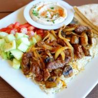 Steak Kabob Plate · Tender pieces of marinated steak with grilled onions and mushrooms, served with hummus, pita...