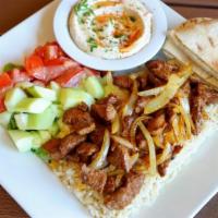 Lamb Shish Kabob Plate · Tender pieces of marinated lamb with grilled onions, served with hummus, pita bread, salad, ...