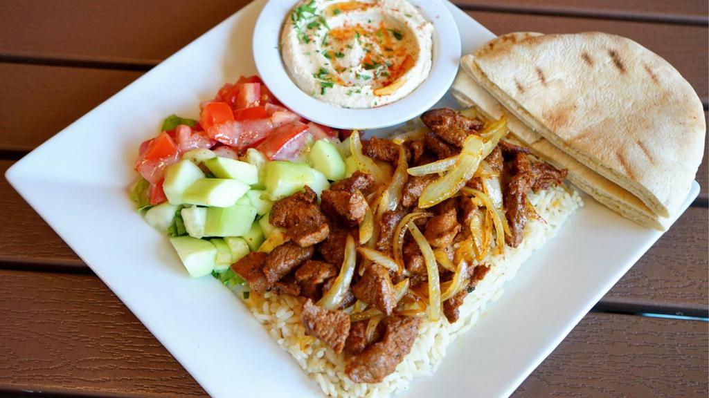 Lamb Shish Kabob Plate · Tender pieces of marinated lamb with grilled onions, served with hummus, pita bread, salad, and choice of rice, brown rice or fries.