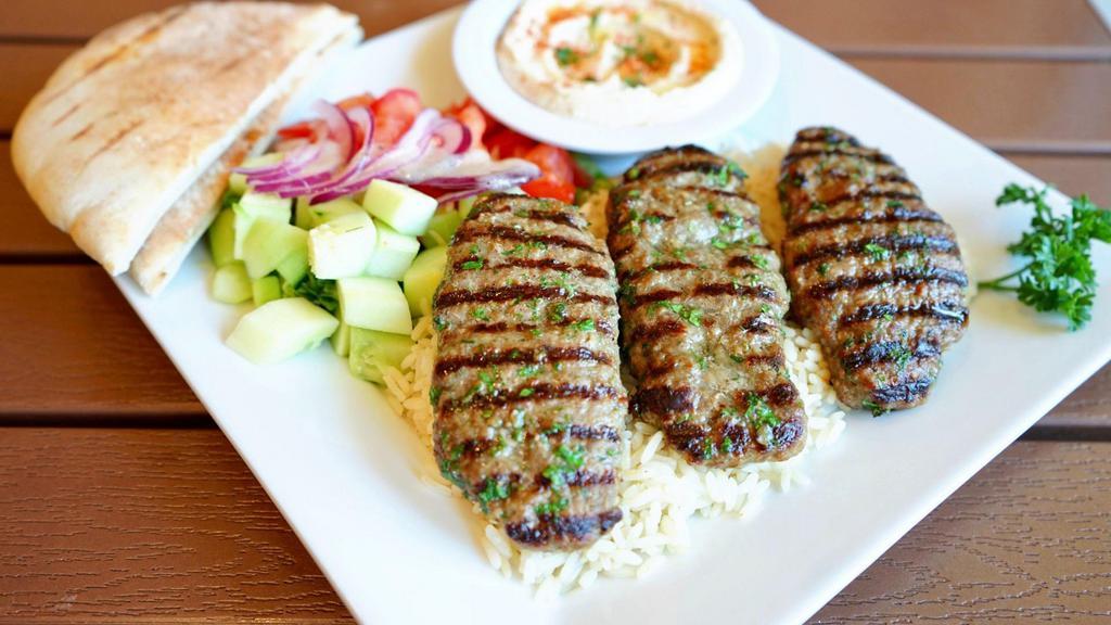Ground Beef House Kabob Plate · Seasoned ground beef, charbroiled to perfection, served with tahini sauce, hummus, pita bread, salad, and choice of rice, brown rice or fries.