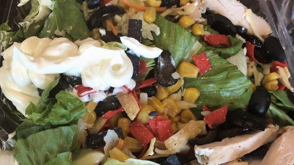 Santa Fe Chicken · Grilled chicken, chopped lettuce, diced tomatoes, sweet corn, black beans, crispy tortilla strips and Jack cheese served with ranch dressing and topped with avocado, sour cream and black olives.