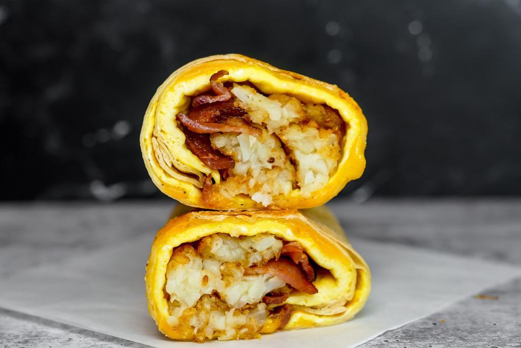 Bacon, Egg & Cheddar Breakfast Burrito · 3 fresh cracked, cage-free scrambled eggs, melted Cheddar cheese, smokey bacon, and crispy potato tots wrapped in a toasted 12” flour tortilla. Comes with avocado salsa verde side.
