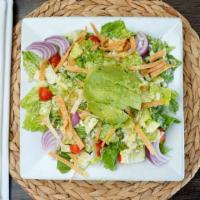 Baja Caesar Salad · Romaine, crisp tortilla strips, red onion, cherry tomato, avocado, Caesar dressing, topped w...