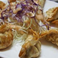 D-1. Gyoza_Fried Dumplings 12 (튀김만두/油炸饺子) · Deep-fried dumplings. Served 12 pieces. Cabbage salad in the photo is not included.