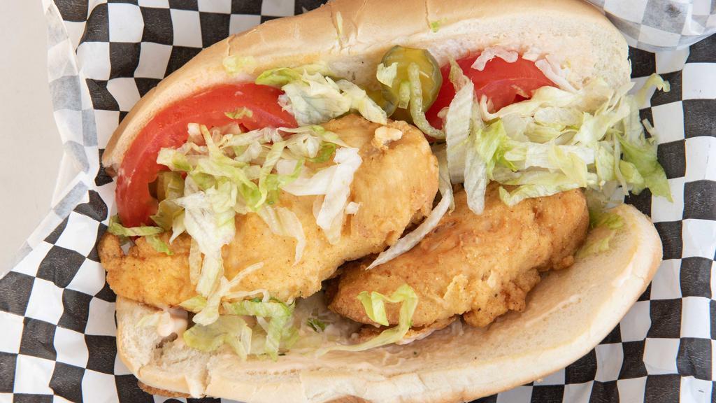 Fried Chicken Po Boy · Fried chicken on a French roll with lettuce, tomato, pickles, and non spicy Cajun Mayo.
