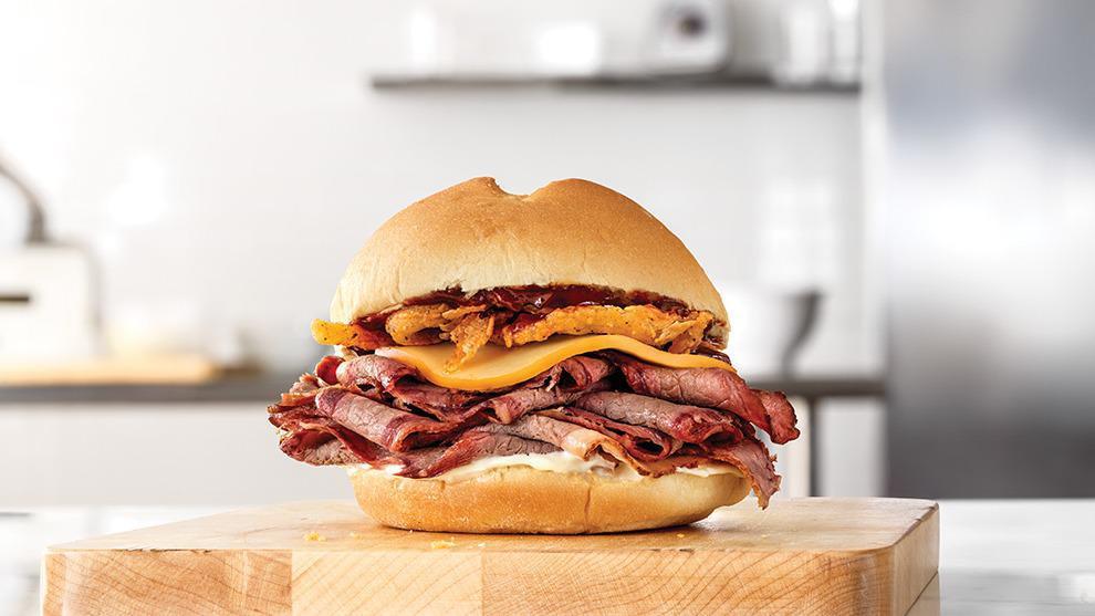 Smokehouse Brisket Sandwich · Sliced smoked brisket with melted Gouda cheese, crispy onions, smoky BBQ sauce and mayonnaise on a toasted specialty roll. Visit arbys.com for nutritional and allergen information.