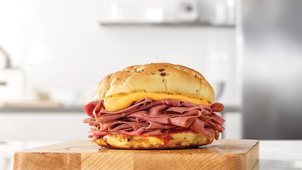 Classic Beef 'N Cheddar · Thinly sliced roast beef with warm cheddar sauce and zesty red ranch sauce on a toasted onion roll. Visit arbys.com for nutritional and allergen information.