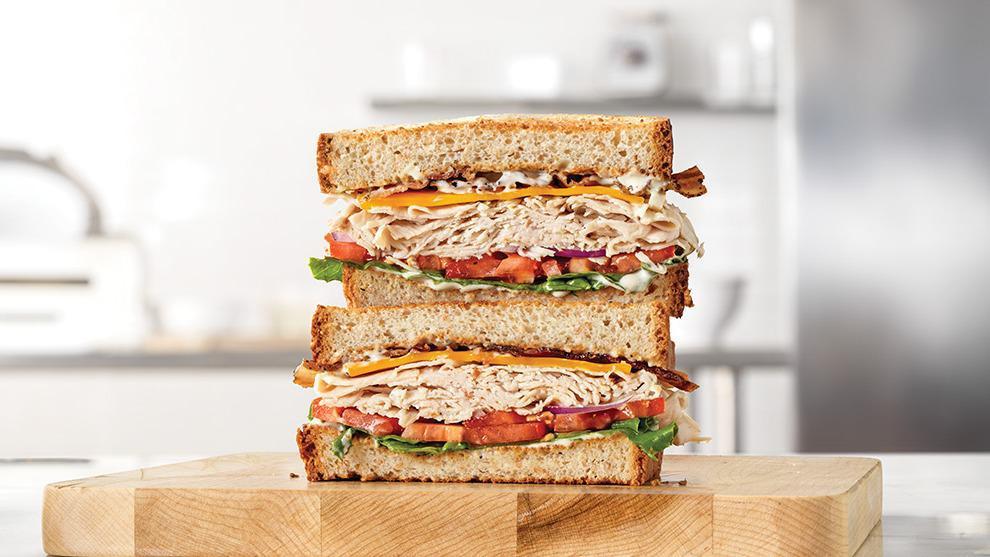 Market Fresh Turkey Ranch & Bacon · Sliced roast turkey with pepper bacon, cheddar cheese, green leaf lettuce, tomato, red onion and parmesan peppercorn ranch sauce on thick sliced honey wheat bread. Visit arbys.com for nutritional and allergen information.