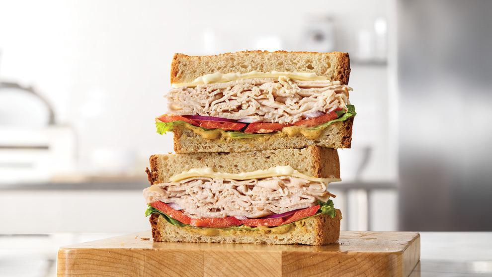 Roast Turkey & Swiss Sandwich · Oven-roasted turkey, ripe tomatoes, lettuce, thinly sliced red onions, Swiss Cheese, mayo and spicy brown honey mustard. Together they make the Roast Turkey & Swiss sandwich, the sandwich roast turkey was made to go on.