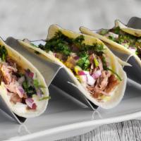 Shack Carnitas Tacos  · 3 Tacos with shredded pork, red onions, cilantro, yellow and white sauce.