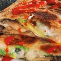 Quesadilla Suiza · A big flour tortilla filled with monterey jack cheese, avocado and crema. Comes with your ch...