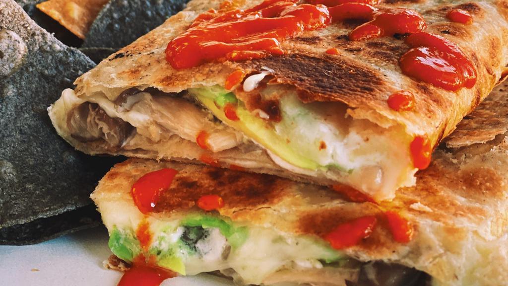 Quesadilla Suiza · A big flour tortilla filled with monterey jack cheese, avocado and crema. Comes with your choice of salsa and Kernel of Truth organic tortilla chips.