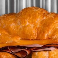 Ham & Cheese On Croissant · Ham and cheese breakfast sandwich with cheddar cheese on a croissant