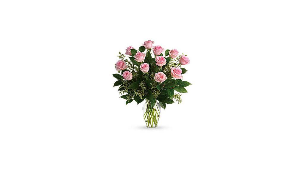 Dozen Pink Roses · Soft as a whisper, this pretty bouquet of a dozen sweet pink roses and deep greens are simply divine for any occasion! Standard - 1 doz roses Deluxe - 1 1/2 doz roses Premium - 2 doz roses.