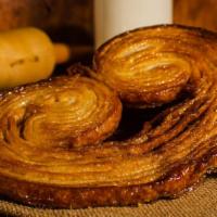 Palmiers · Toasted puff pastry is made with alternating layers of dough and butter, rolled and folded t...