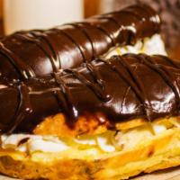 Eclair · French dessert made in a bun with choux pastry, filled with real cream and topped with choco...