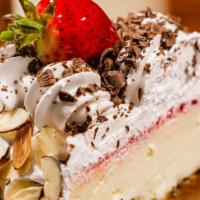 Cheesecake Slice · New York-style cheesecake with whip cream and decorated with strawberries / Pastel de queso ...