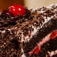 Black Forest Cake Slice · Chocolate cake filled with cherries and custard, decorated with grated chocolate, grass suga...