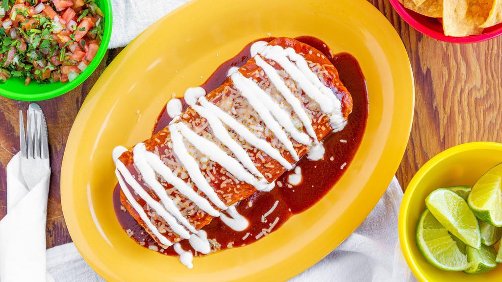 Wet Burrito · Flour tortilla, choice of meat, rice, beans, sour cream cheese and pico de gallo topped with red sauce.