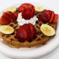 Syrup Waffle · Syrup drizzled over a waffle topped with whipped cream and powdered sugar.