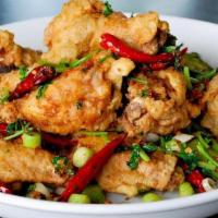 Salt & Pepper Chicken Wings (6) · Spicy. Crispy chicken wings, dried chili, serrano chili, fried garlic, scallion, cilantro, s...