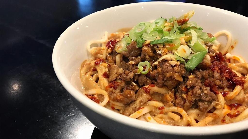 Dan Dan Noodles · Steamed noodles, minced pork, spicy sesame peanut sauce, chili oil, crushed peanuts and scallions.