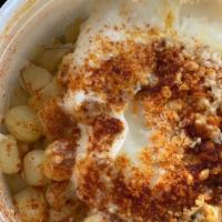 Esquites · Corn off the cob in a cup that includes mayo, cheese, butter, limon, chile powder.