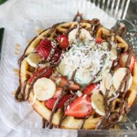 Dessert Waffle · Home made waffle batter, fresh stawberry slices, fresh banana slices, sliced almonds, Nutell...