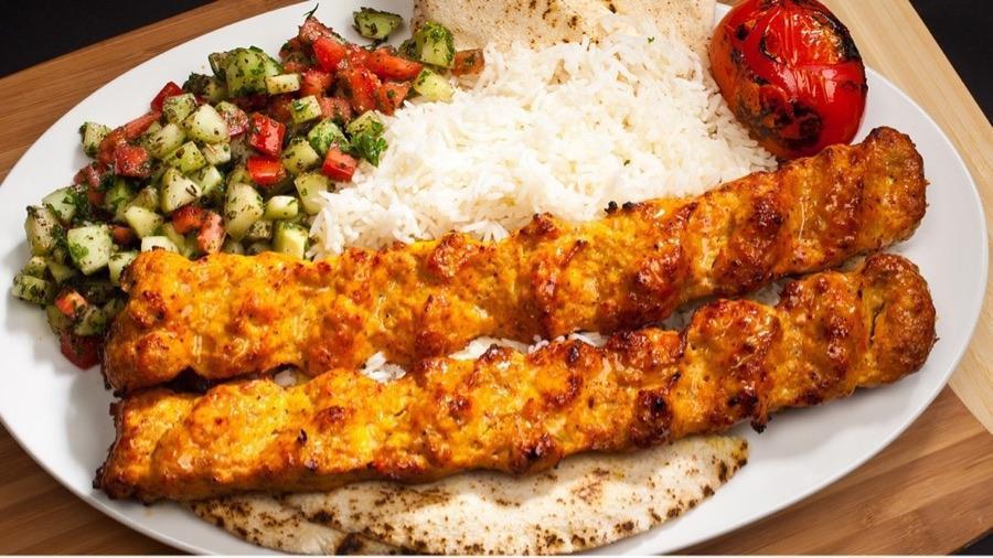 #12B Persian Koubideh Chicken · Two Skewers of Ground Chicken perfectly seasoned served with Rice, Pita Bread, Shirazi Salad, Grilled Tomatoes and Peppers