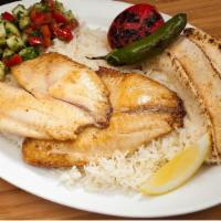 #17A Tilapia · Boneless skinless tilapia fish served with Rice, Pita Bread, Shirazi Salad, Grilled Tomatoes...