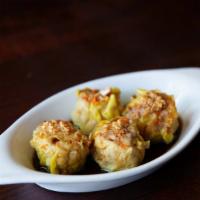 Thai Dim Sum · Open-faced steamed pork and shrimp dumpling. Served with sweet and savory dipping sauce.