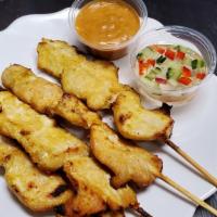 Chicken Satay · Four skewers of seasoned chicken marinated and grilled, served with a peanut sauce and cucum...
