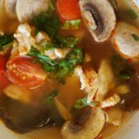 Tom Yum · Thai hot and sour soup with mushrooms, tomato, and cilantro.