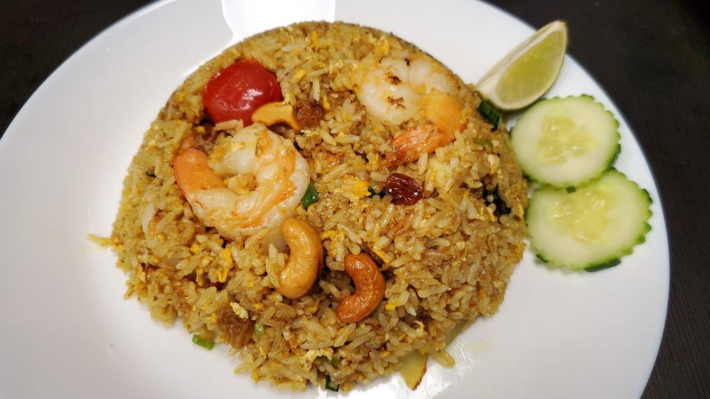 Pineapple Fried Rice · Fried rice with pineapple, shrimp, chicken, scallion, cashew nut, raisin, tomato, and curry powder.
