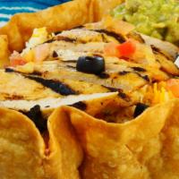 Tostada Grande · A large, crispy flour tortilla shell filled with your choice of meat and beans, topped with ...