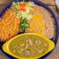 Chile Verde · Slow simmered pork, mild tomatillo, sauce, green peppers, onions, spices with rice and bean.