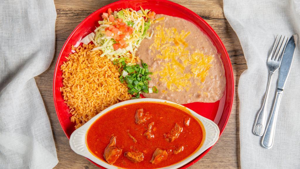Chile Colorado · Slow simmered beef, mild red chile sauce with rice and beans.
