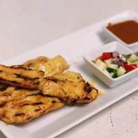 A-1. Chicken Satay · Grilled skewered meat infused with Thai spices. Served with a crisp cucumber salad and dress...