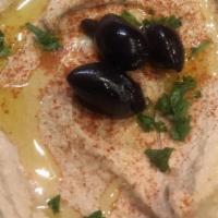 Hummus · Garbanzo  beans blended eith Tahini, olive oil and Lemon juice & Garlic