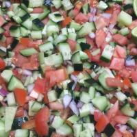 Salad Shirazi · Diced tomato, onion, cucumber &  olive oil & lemon juice