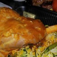 Lamb Shank · Our specialty dish. Lamb shank Served w/Basmati rice &  includes(Tomato/Onion/zucchini/Jalap...
