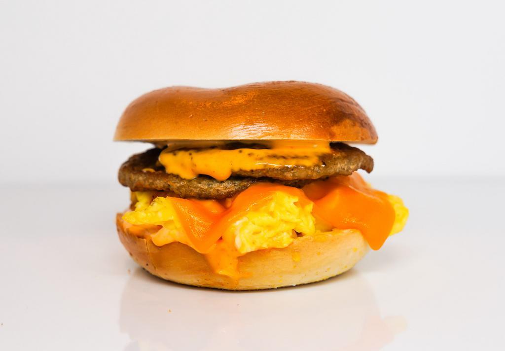 Bagel, Sausage, Egg, & Cheddar Sandwich · 2 scrambled eggs, melted Cheddar cheese, breakfast sausage, and Sriracha aioli on a toasted bagel.