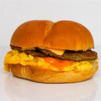 Kaiser Roll, Sausage, Egg, & Cheddar Sandwich · 2 scrambled eggs, melted Cheddar cheese, breakfast sausage, and Sriracha aioli on a warm kai...