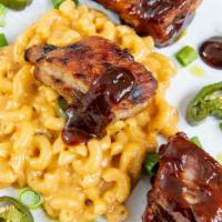 Mac & Ribs · Elbow pasta in creamy cheesy alfredo sauce with ribs, four pieces.